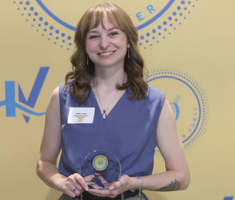Kelly Finely poses with her 40 Under Forty award during the Illinois Valley Chamber of Commerce Champions of Change Awards Night on Wednesday, May 6, 2026 at the Westclox Event Center in Peru.