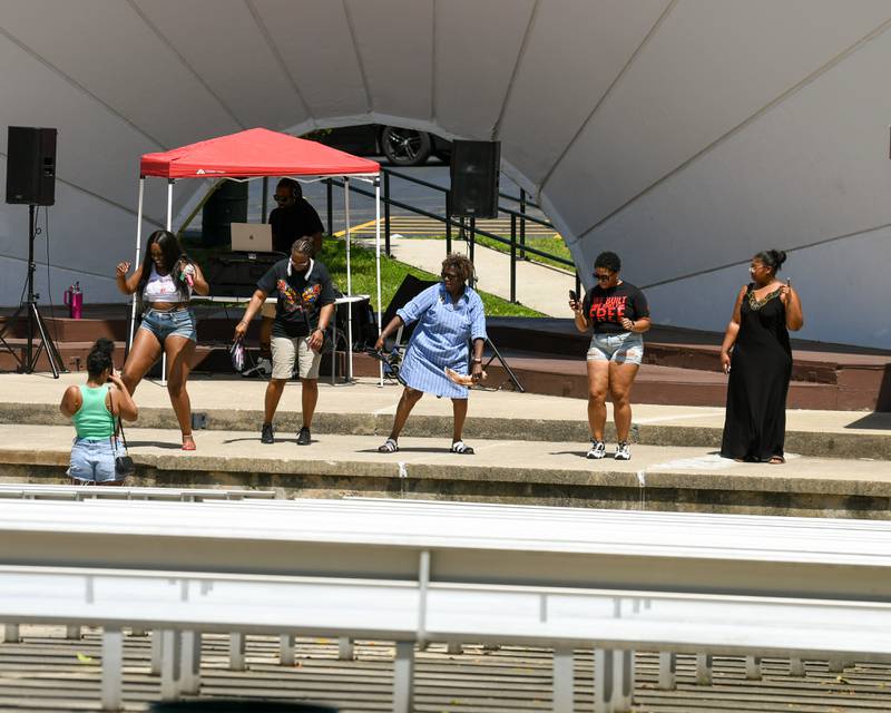 Event-goers don't mind the heat while dancing on stage on Sunday, June 22, 2025, during the annual Juneteenth Community Celebration held at Hopkins Park in DeKalb.