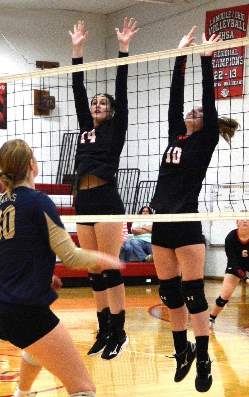 LaMoille's Claire Lovgren and Olivia Sadnick guard the net against Hiawatha Tuesday at Dean Madsen Gymnasium at LaMoille.
