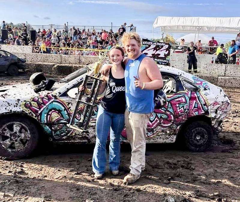 Bureau County Fair Queen Kelsea Mongan of Princeton celebrates winning the demo derby with her brother, Kody, who also drove in it.