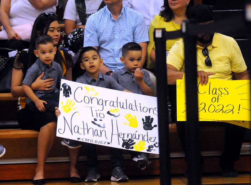 Children hold up congratulating Nathan Hernandez Sunday, May 22, 2022, during the Harvard High School Commencement Ceremony in Harvard .