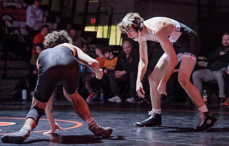 St. Charles East’s Tyler Guerra and Marian Central’s Will Gillaspie wrestle at 144 pounds during a match in St. Charles on Wednesday, December 20, 2023.