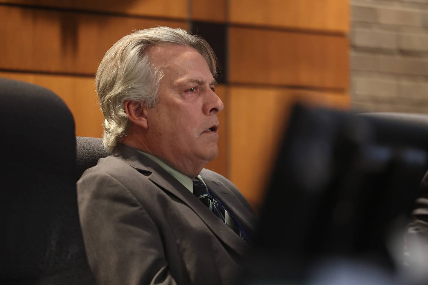 District 1 Council Larry Hug sits in on a hearing on the validity of nominating petitions of two City Council candidates at the Joliet City Electoral Board meeting on January 4th.