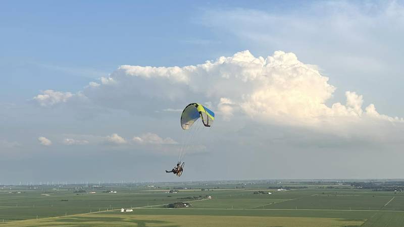 A Streator PPG flyer takes to the skies, demonstrating the excitement of powered paragliding. The group's flights are a blend of adventure and community spirit.