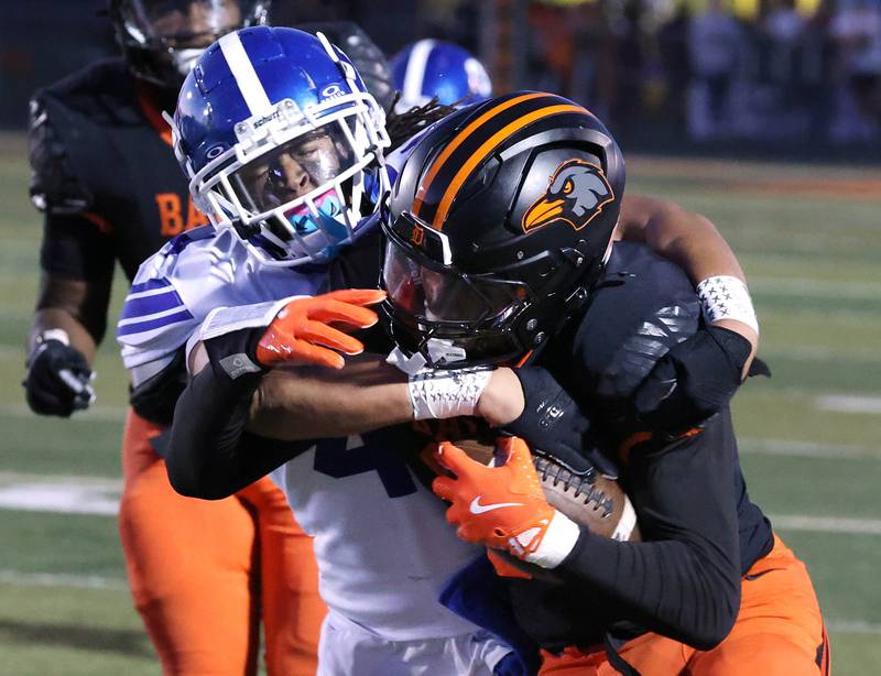DeKalb's Davon Grant is brought down by Phillips' Kevin Billingslea III Friday, Sept. 5, 2025, during their game at DeKalb High School.