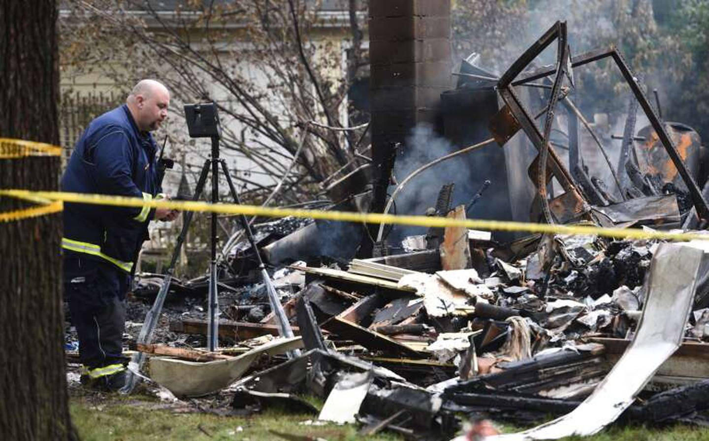 Officials investigate the scene the morning after a house exploded in the 23500 block of North Overhill Road near Lake Zurich.