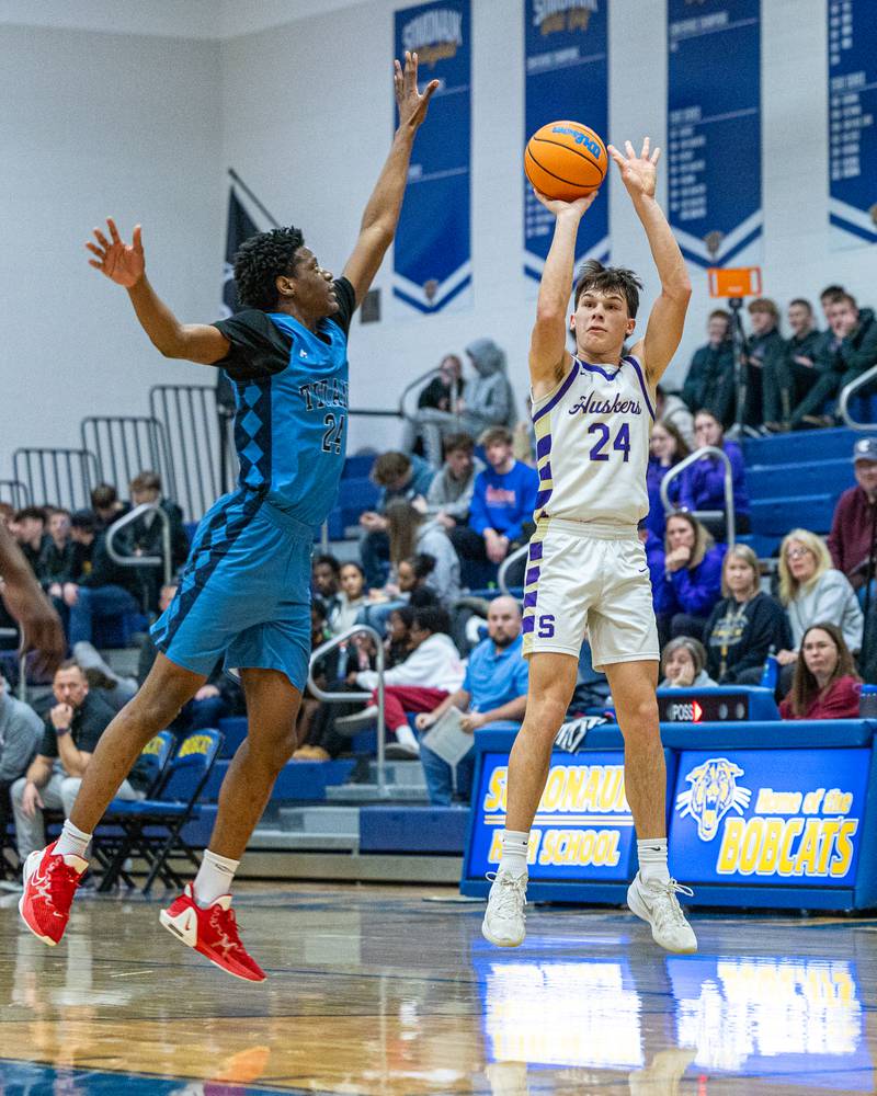 Payton Twait (24) of Serena shoots 3-pointer as Omar Njikam (24) of IMSA leaps to contest shot in the quarterfinals of the Little Ten Conference Tournament on Monday, Feb. 2, 2026 at Somonauk High School in Somonauk.