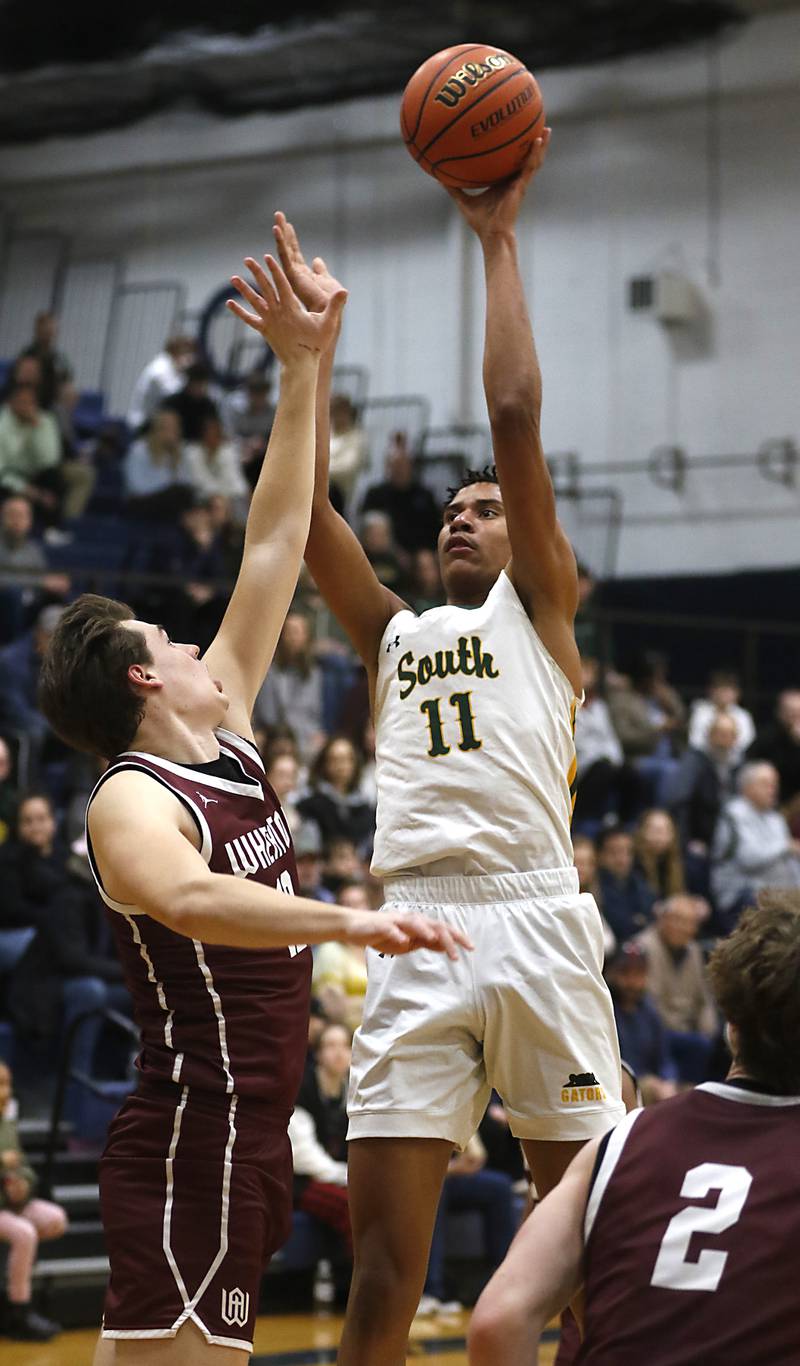 Crystal Lake South's Christian Rohde shoots the ball over Wheaton Academy's Ben Dehaan during the IHSA Class 3A Cary-Grove Boys Basketball Regional Championship game on Friday, Feb. 23, 2024 at Cary-Grove High School.