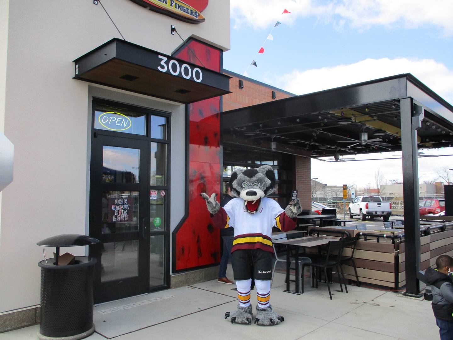 The mascot for the Chicago Wolves hockey team makes an appearance at the Raising Cane's Chicken Fingers opening in Joliet on Tuesday, March 8, 2022.
