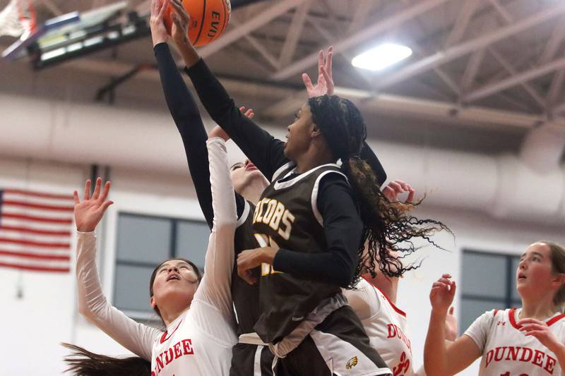 Jacobs’ Bri Ramsey, center, battles others for a rebound in varsity girls basketball on Friday, Dec. 12, 2025, at Dundee-Crown High School in Carpentersville.