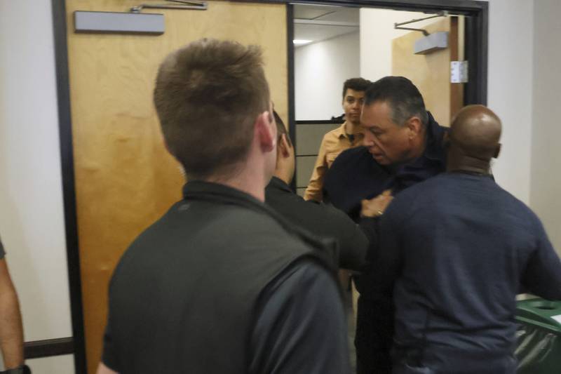 U.S. Sen. Alex Padilla, D-Calif., is pushed out of the room as Homeland Security Secretary Kristi Noem holds a news conference regarding the recent protests in Los Angeles on Thursday, June 12, 2025. (AP Photo/Etienne Laurent)
