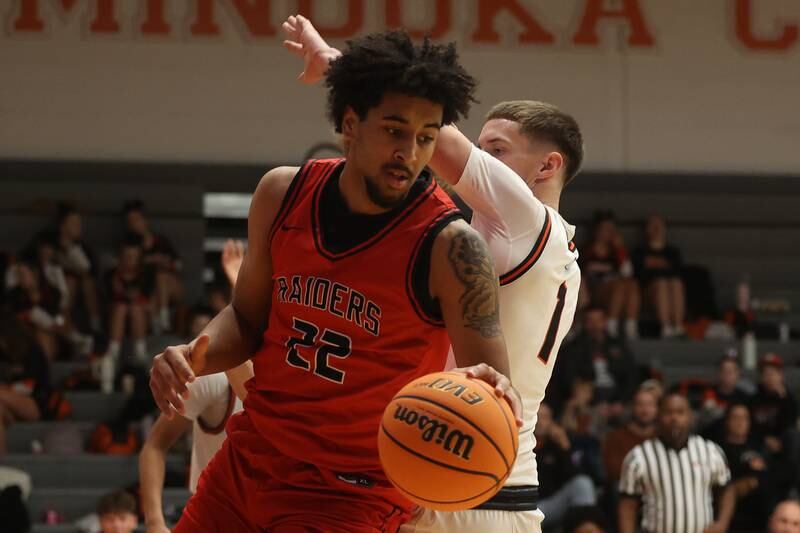 Bolingbrook’s JT Pettigrew rolls out of the paint with the ball against Minooka on Tuesday, Dec. 17, 2024 in Minooka.