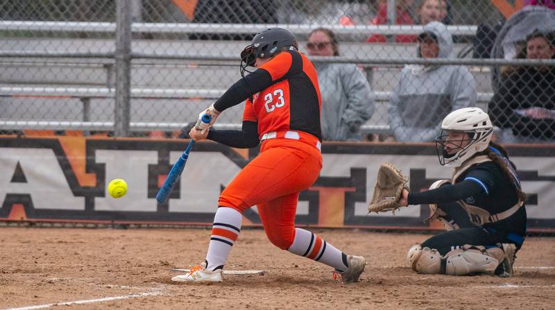 St. Charles East's Katie Morgan (23) singles against St. Charles North during a softball game at St. Charles East High School on Monday, April 25, 2022.