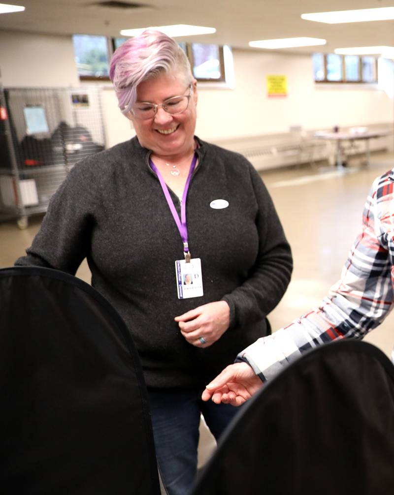 Election judge Marie Bennett assists a voter in the 2025 Consolidated Election on Tuesday, April 1, 2025 at the Sugar Grove Township Community Building in Sugar Grove.
