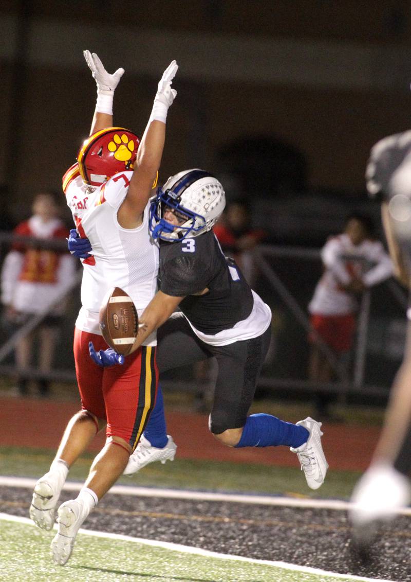St. Charles North’s Jake Mettetal (right) attempts a catch blocked by Batavia’s RJ Bohr (left) during a game at St. Charles North on Friday, Sept. 15, 2023.