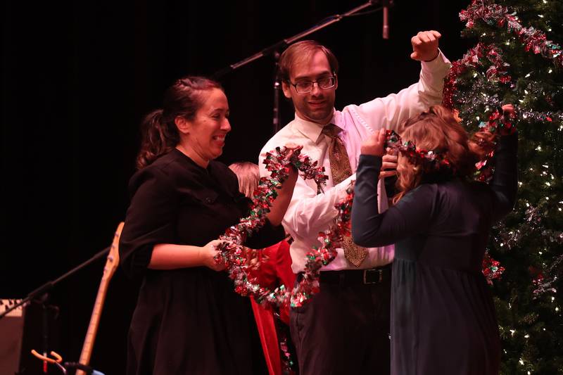 Actors decorate the Christmas tree for a scene at the A Very Rialto Christmas show on Monday, November 21st in Joliet.