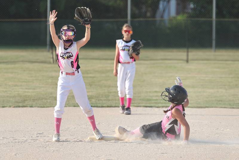 Kishwaukee Valley Storm 10u player Emma Wilczek tells the catcher to hold the throw as a Poplar Grove player slides in safely with a stolen base Wednesday, June 21, 2023, during a scrimmage game at the Sycamore Community Sports Complex. The Kishwaukee Valley Storm is hosting the Storm Dayz tournament this weekend which draws about 70 teams and runs Friday through Sunday in Sycamore.