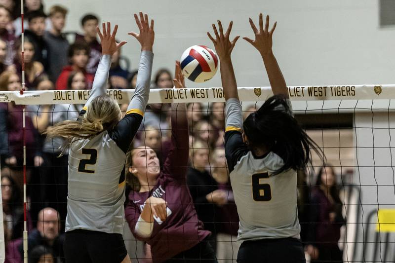 Joliet West's Lexie Grevengoed and Faith Jordan attempt to block a hit from Lockport's Olivia Maier during a 4A Sectional Finals varsity volleyball game at Joliet West on Nov. 6, 2025.