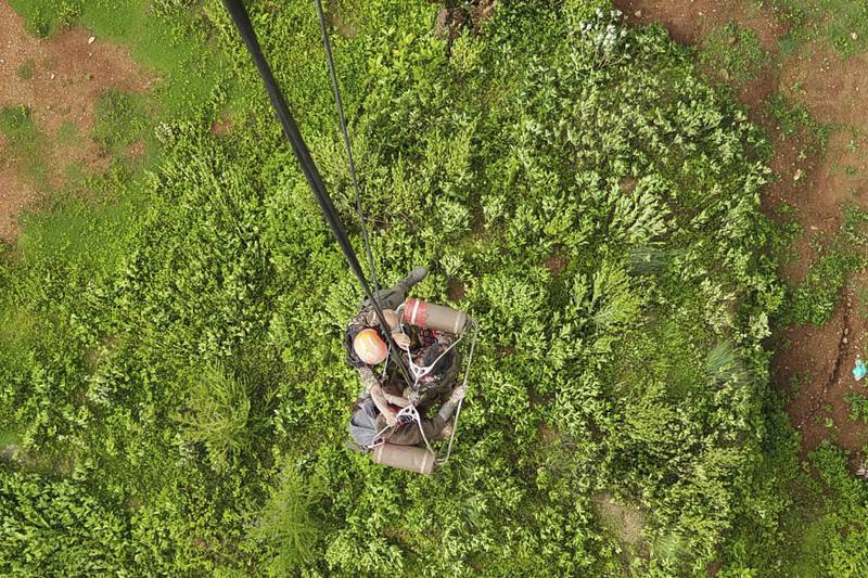 Army personnel rescue people stranded by the flooding on the Bhotekoshi River 120 kilometers (75 miles) north of Kathmandu, Nepal, Tuesday, July 8, 2025. (Nepal Army via AP)