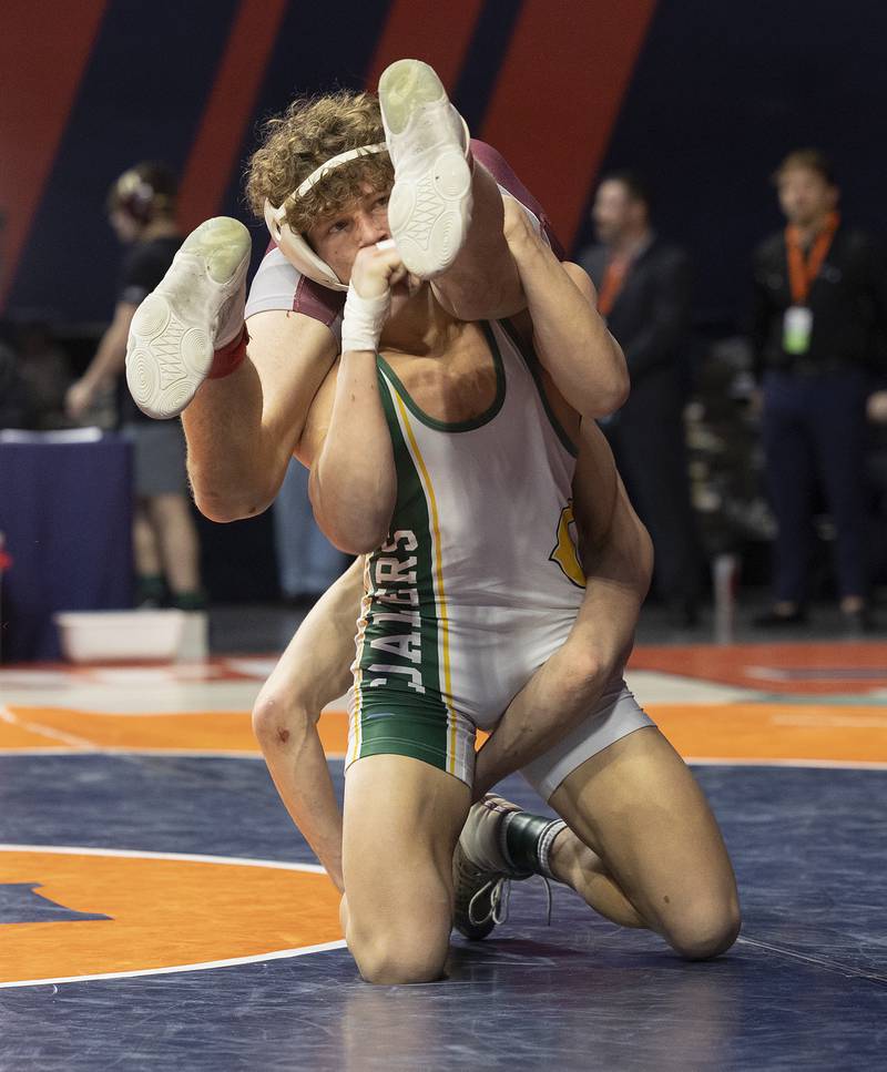 Coal City’s Cody Widlowski flips Taylor Finley of Unity Christian in the 138 pound weight class of the 1A state individual wrestling finals Saturday, Feb. 22, 2025, at State Farm Center in Champaign.