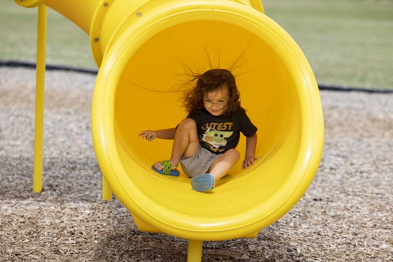 After being hesitant at first, Violet Lucas, 3, is full of smiles and static electricity after completing a trip down the slide at Rock Falls’ Centennial Park Thursday, July 6, 2023.
