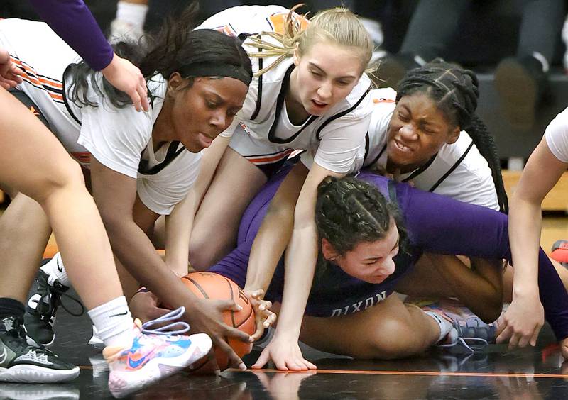 DeKalb and Dixon players scramble for a loose ball during their game Monday, Jan. 23, 2023, at DeKalb High School.