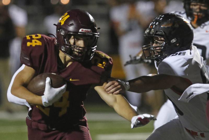 Richmond-Burton's Hunter Carley tries to avoid Sandwich's Jeffrey Ashley during a Kishwaukee River Conference football game on Friday, Oct. 4, 2024, at Richmond-Burton High School.