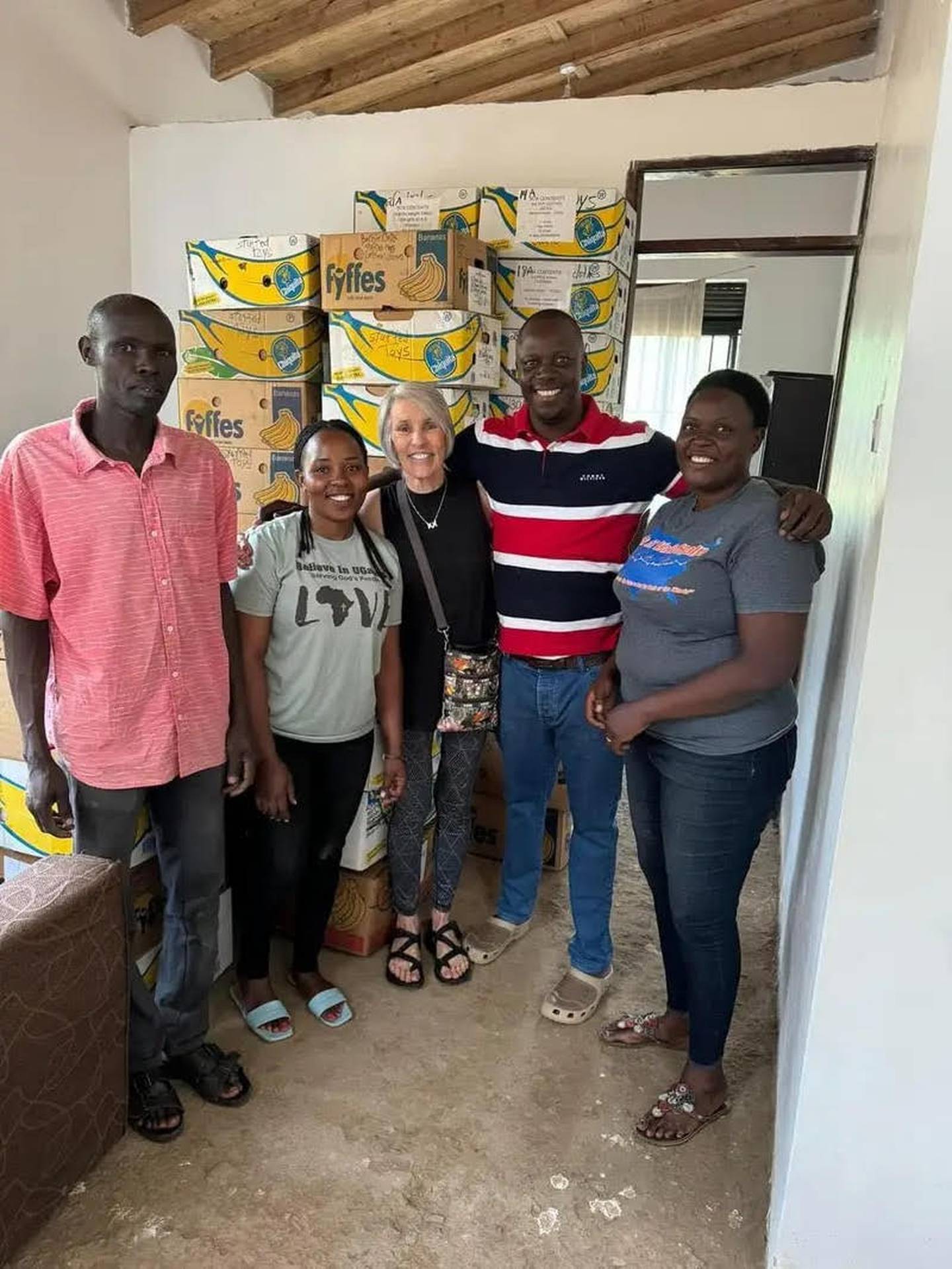Debbie Damron of Ottawa (middle) with (from left) John, Jackie, Milton and Faith of ITI, a community-based support group in Uganda. Damron has been traveling to rural Uganda since 2008 to serve the poor.