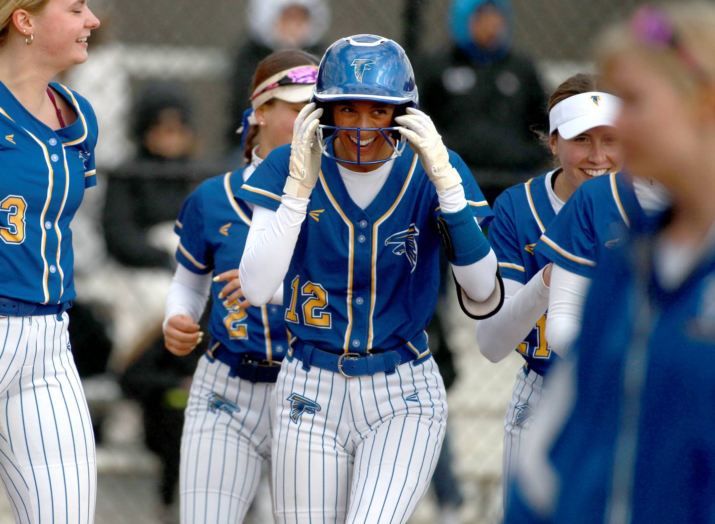 Wheaton North's Abby Del Preto (center) celebrates with her team after scoring a home run during a game against St. Charles North on Tuesday, April 15, 2025 in St. Charles.