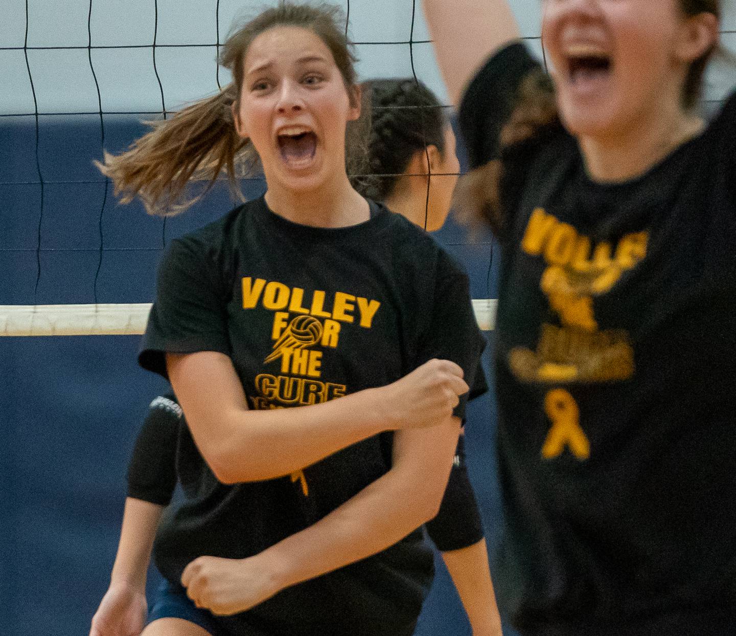 Oswego East's Kylie Kany (left) reacts after a score against Oswego during a volleyball match at Oswego East High School on Thursday, Sep 15, 2022.