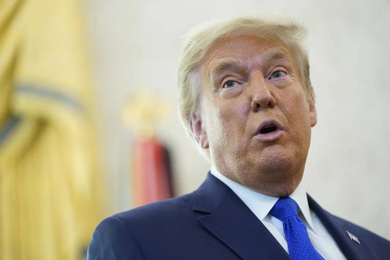 President Donald Trump speaks after awarding the Presidential Medal of Freedom, the highest civilian honor, to Olympic gold medalist and former University of Iowa wrestling coach Dan Gable in the Oval Office of the White House, Monday, Dec. 7, 2020, in Washington. (AP Photo/Patrick Semansky)