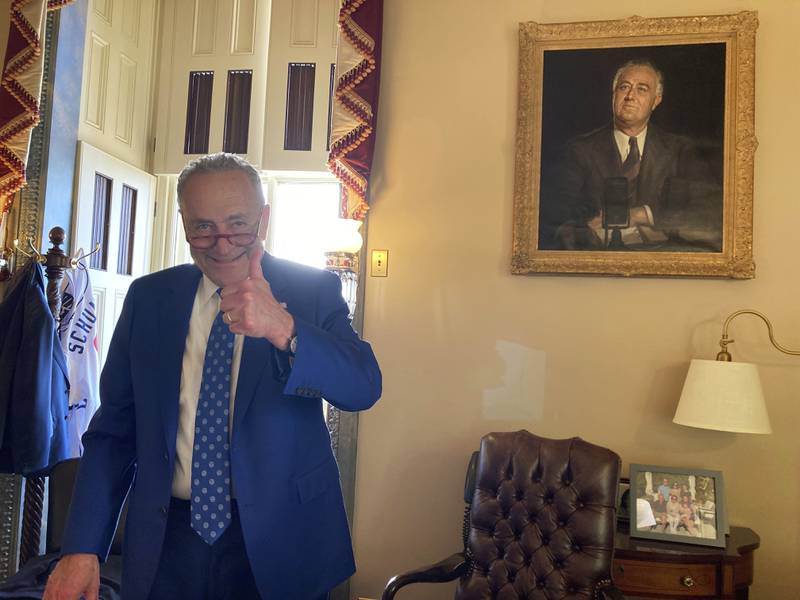 U.S. Sen. Chuck Schumer, D-N.Y., gives a thumbs-up in his office after the Senate approved Democrats' big election-year economic package, in Washington, Sunday, Aug. 7, 2022. (AP Photo/Lisa Mascaro)