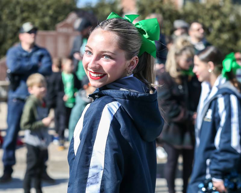 A cheerleader with the 2025 Lemont State champs march with her teammates in the Lemont St. Pat's Day Parade on Saturday, March 8, 2025  in Lemont.
