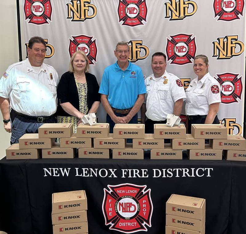 The New Lenox Fire Protection District recently received a donation for the purchase of Knox Boxes for its residential Knox Box Loan/Purchase program. Pictured (L to R): James Brown, NLFD; Margaret Batkiewicz, Family Services Foundation of New Lenox Township; Jim Pitcairn, New Lenox Township; NLFD Fire Chief Adam Riegel; Marisa Tomich, NLFD