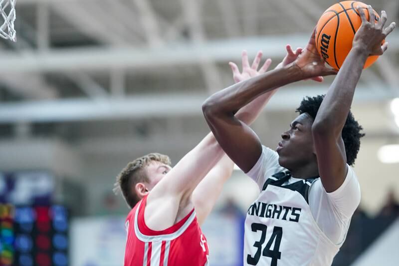 Kaneland’s Jeffrey Hassan (34) shoots the ball in the post against Streator's Nolan Lukach (44) during a semi-final basketball game in the 61st annual Plano Christmas Classic at Plano High School on Friday, December 27, 2024.