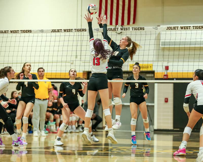 Joliet West's Peyton Darguzis (18) tips the ball over the net during regional final volleyball match between Bolingbrook at Joliet West.  Oct 26, 2023.