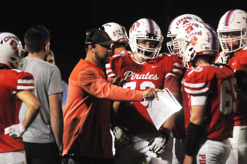 Ottawa head coach Chad Gross talks with his team during a timeout in their game against Woodstock North at King Field on Friday, Sept. 29, 2023.