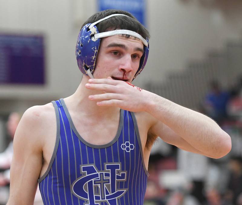 Newman's Carter Rude heads to the trainer for a bloody nose during his match with Yorkville Christian's Grason Johnson at the 1A Oregon Wrestling Sectional on Friday night.