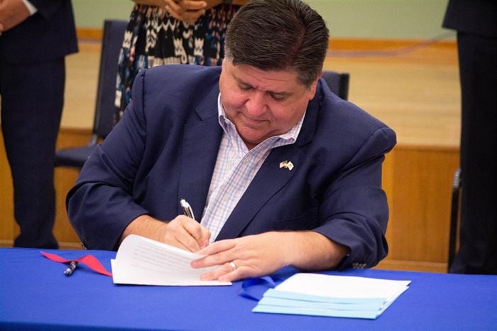 Gov. JB Pritzker is pictured signing a bill in a file photo. Several new laws will go into effect in Illinois on Jan. 1, 2023.