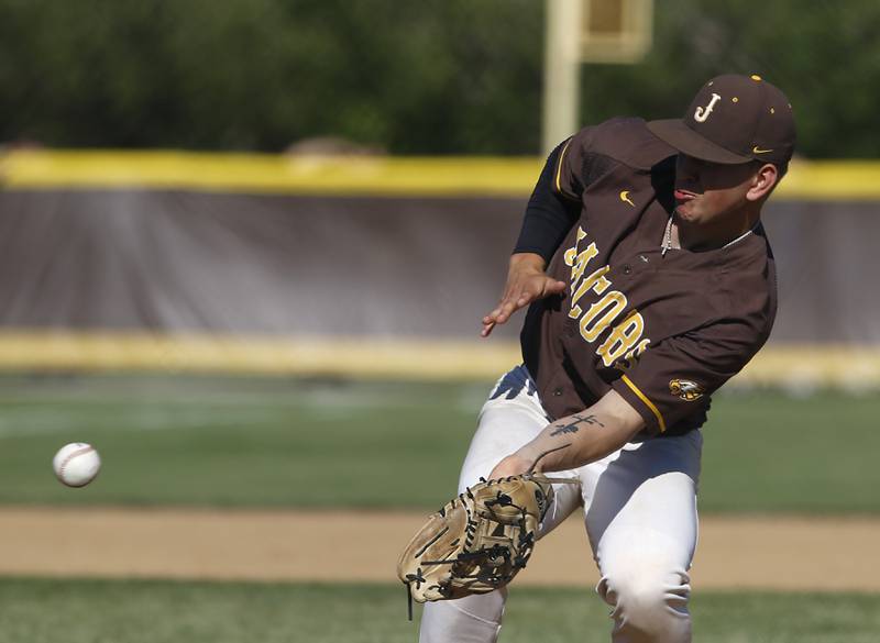 Jacobs's Anthony Edge tries to field the ball hit back at him while pitching during a IHSA Class 4A baseball sectional semi-final baseball game between Jacobs and Huntley at Jacobs High School in Algonquin.