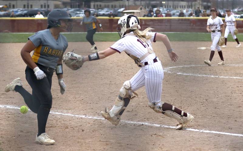 Harvard's Nayeli Sanchez runs to home as the Richmond-Burton's Rebecca Lanz tries to field the throw during a Kishwaukee River Conference softball game on Thursday, April 9, 2026, at Richmond-Burton High School.
