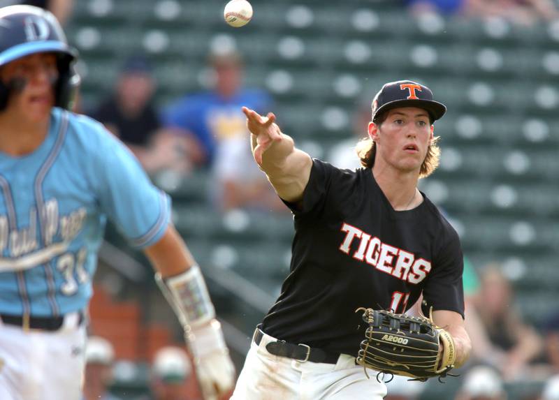 Crystal Lake Central pitcher Connor Gibour fires to first base to force out a runner in supersectional baseball action against DePaul College Prep at Wintrust Field in Schaumburg Monday.