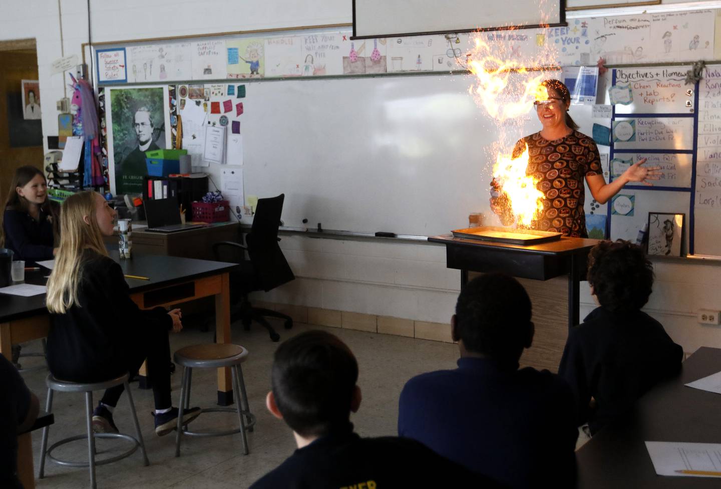 Teacher Ally Egert performs an experiment with coffee creamer and fire  for her sixth-grade students Monday, May 1, 2023, at Montini Catholic School in McHenry.