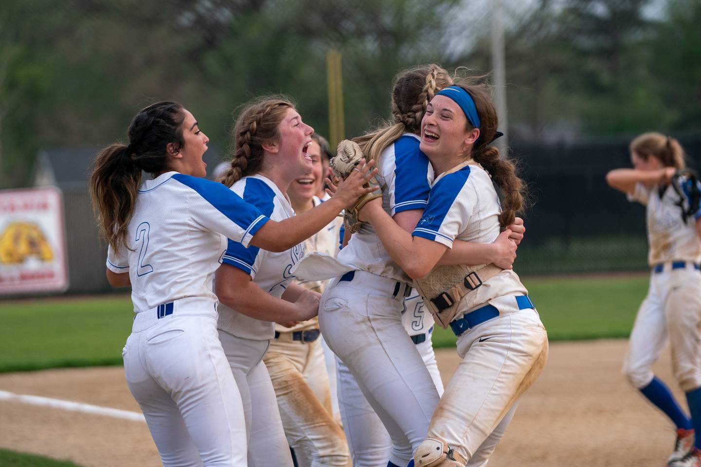 St. Charles North's Paige Murray (left) and St. Charles North's Sophia Olman (right) hugs as they celebrate their victory against Lake Park during a softball game at St. Charles North High School on Wednesday, May 11, 2022.