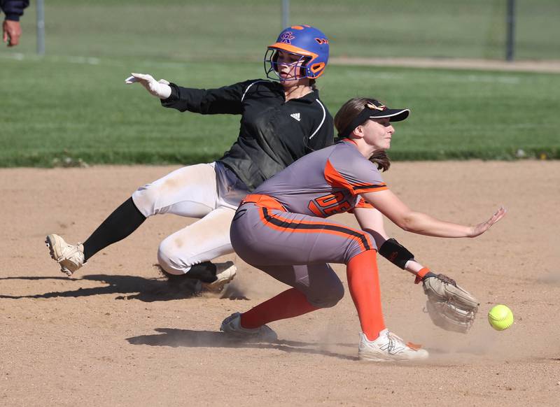 Genoa-Kingston's Olivia Vasak slides in with a stolen base as DeKalb's Hazel Montavon takes the throw Thursday, May 8, 2025, during their game at Genoa-Kingston High School.