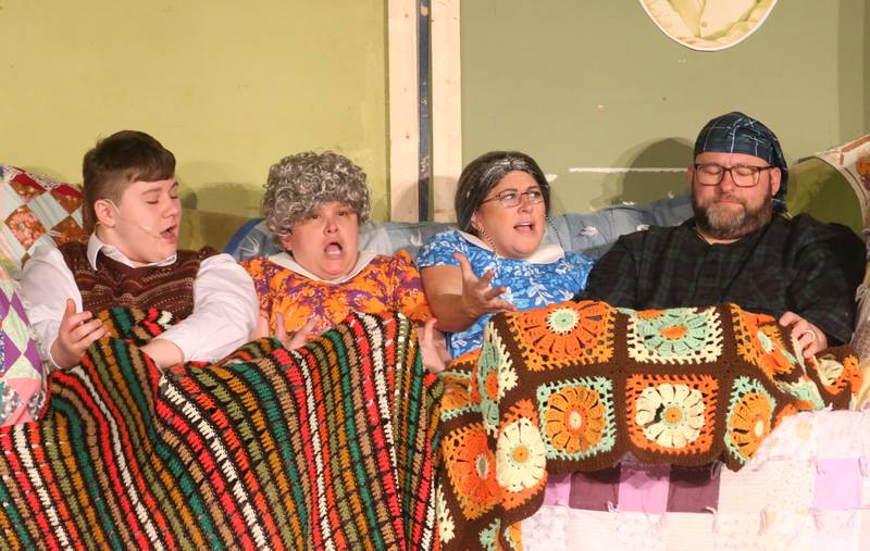 Grandpa Joe, played by Eric Vipond, Grandma Josephine, played by Kim Jalley,  Grandma Georgina, played by Jess Lenkaitis and Grandpa George, played by Charlie Lenkaitis act out a scene during a performance of Willy Wonka on Thursday, March 16, 2023 at Putnam County High School.