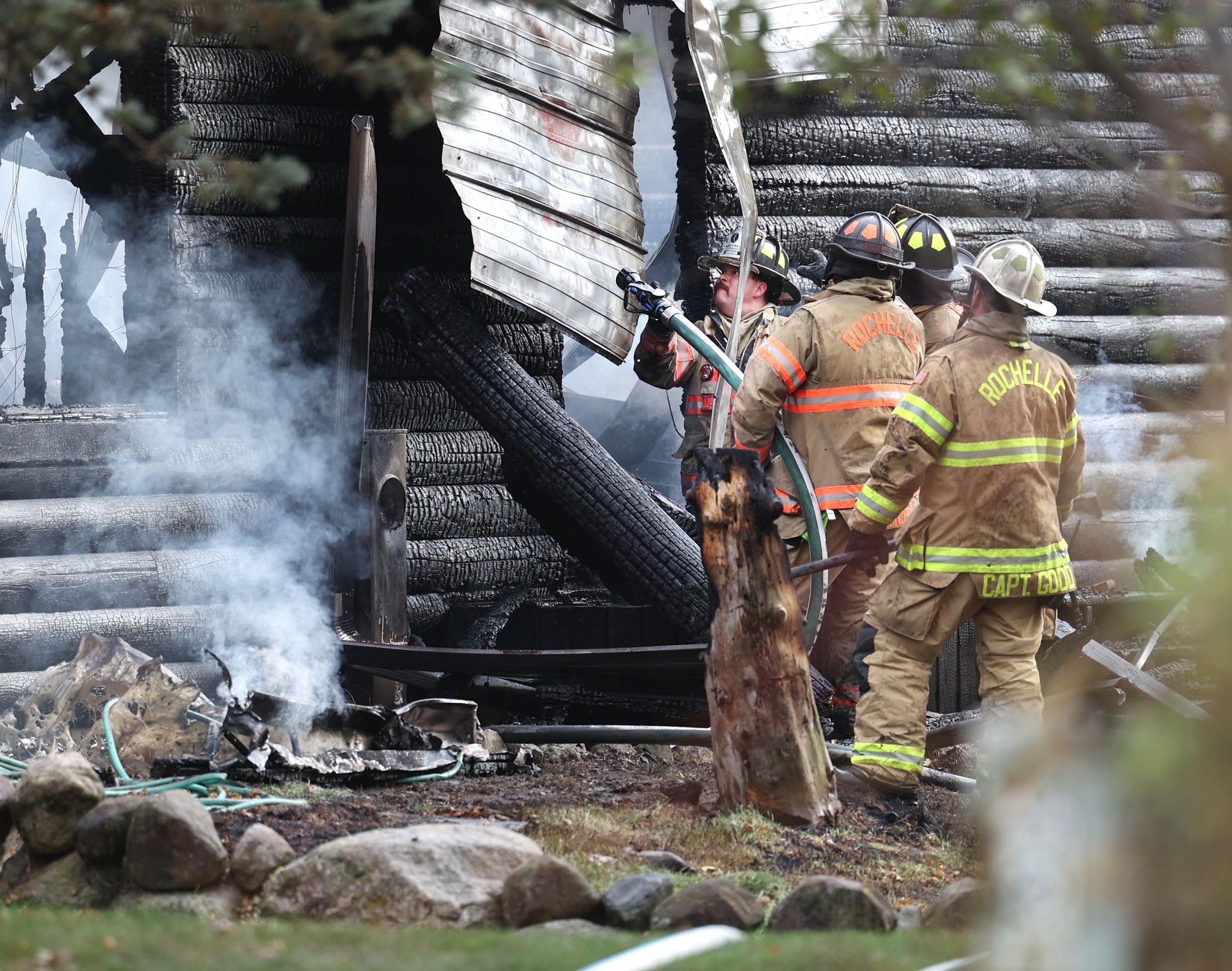 Rochelle firefighters prepare to put water on a house that was destroyed by fire Thursday, Nov. 13, 2025, near Shabbona Grove Road in Shabbona. Several local departments responded to the general alarm structure fire.