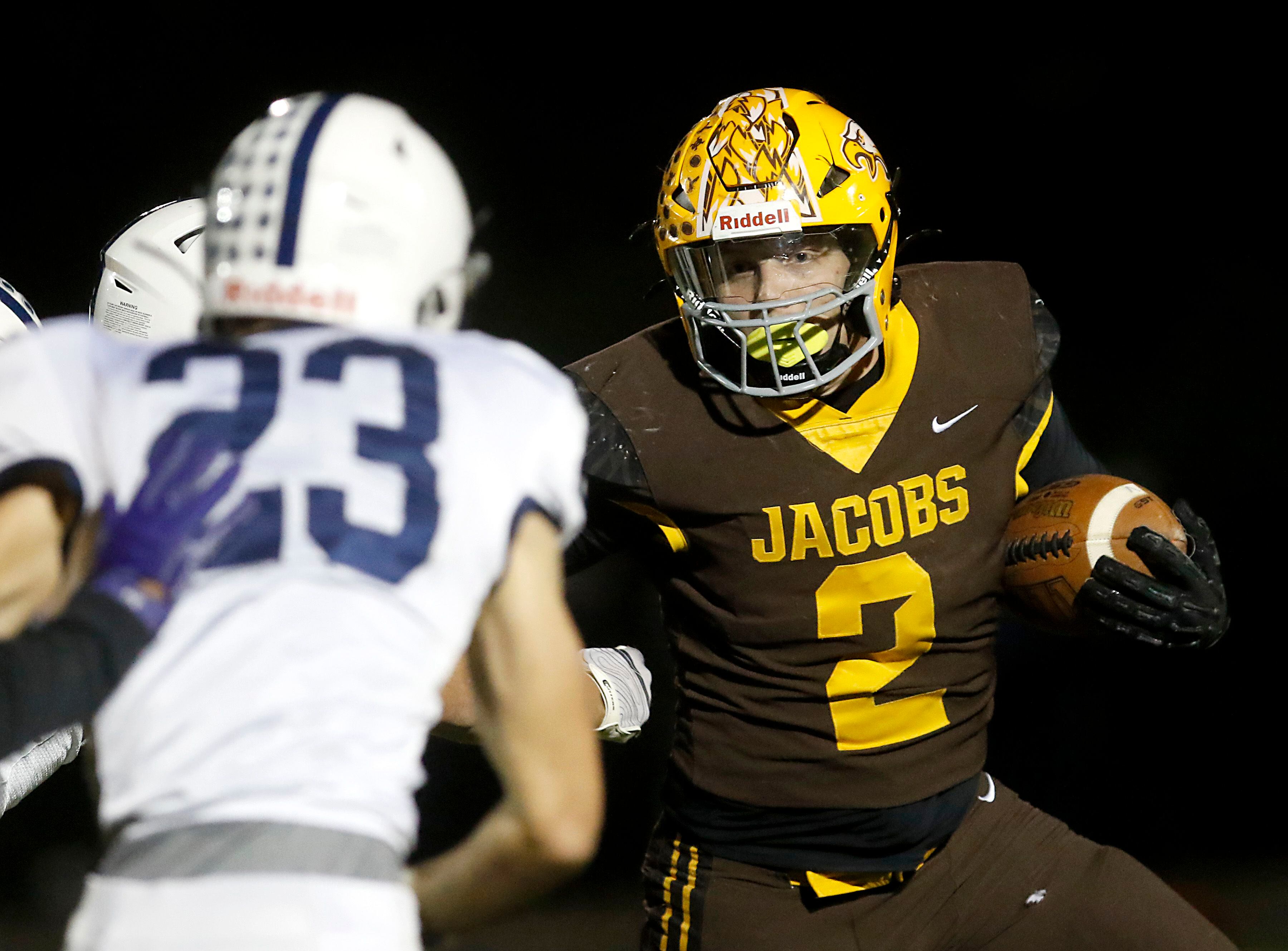 Jacobs' Caden DuMelle tries to get outside the pursuit of Cary-Grove's Lance Moore during a Fox Valley Conference game earlier this season at Jacobs High School in Algonquin.
