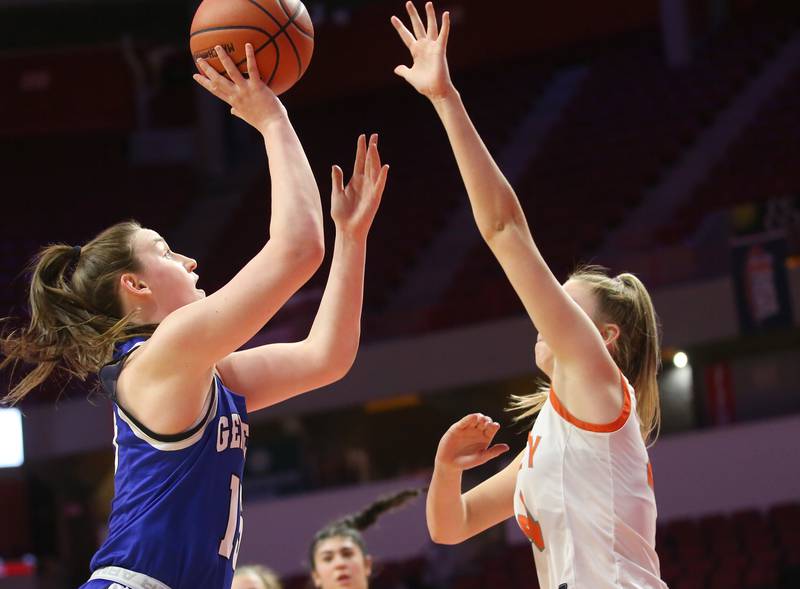 Hersey's Lily Larson runs in the lane to score over Geneva's Cassidy Arni shoots a shot over Hersey's Annika Manthy during the Class 4A third place game on Friday, March 3, 2023 at CEFCU Arena in Normal.
