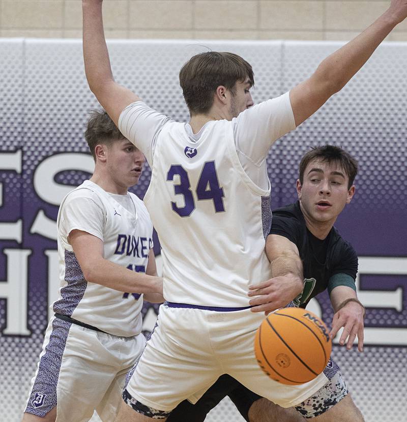 Alleman’s Jack Wendt makes a pass while being guarded by Dixon’s Jakob Nicklaus Wednesday, Jan. 28, 2026.